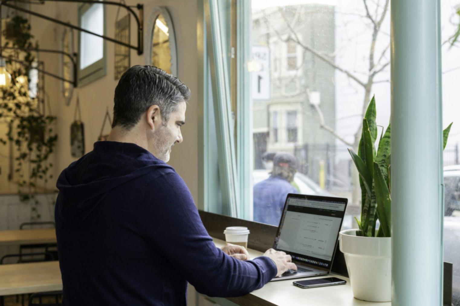 Organized workspace showing budget planning materials and laptop with financial spreadsheet